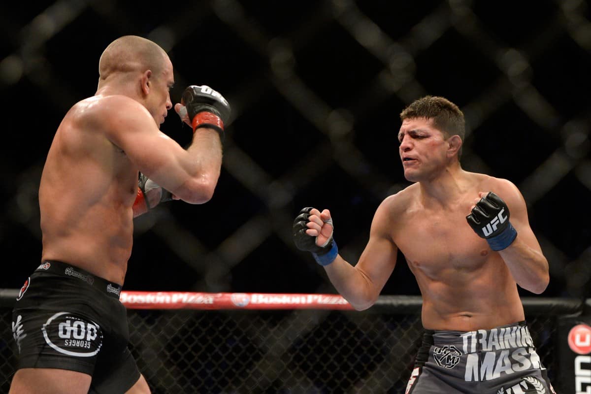 Mar 16, 2013; Montreal, Quebec, CAN; Nick Diaz (blue) taunts Georges St.Pierre (red) during their Welterweight title bout at UFC 158 at the Bell Centre. Mandatory Credit: Eric Bolte-USA TODAY Sports