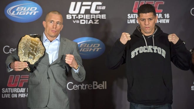 Mixed Martial Arts fighters Georges St-Pierre, left, and Nick Diaz pose for the media following their news conference in Montreal, Thursday, March 14, 2013. The pair will meet in a UFC 158 title fight in Montreal on Saturday. (AP Photo/The Canadian Press, Graham Hughes)