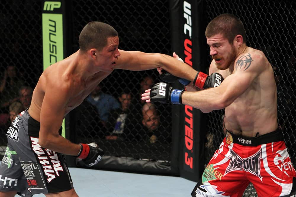 EAST RUTHERFORD, NJ - MAY 05: Nate Diaz (L) punches Jim Miller (R) during thier Lightweight bout at Izod Center on May 5, 2012 in East Rutherford, New Jersey. (Photo by Josh Hedges/Zuffa LLC/Zuffa LLC via Getty Images)