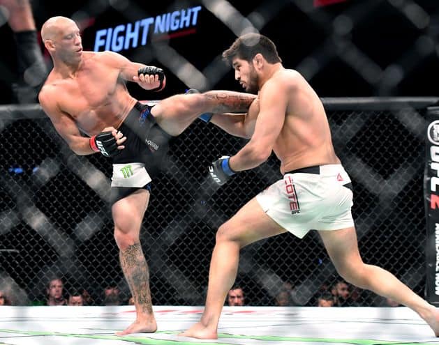 Jun 18, 2016; Ottawa, Ontario, Canada; Patrick Cote (blue gloves) fights Donald Cerrone (red gloves) in a welterweight bout during UFC Fight Night at TD Place Arena. Mandatory Credit: Marc DesRosiers-USA TODAY Sports