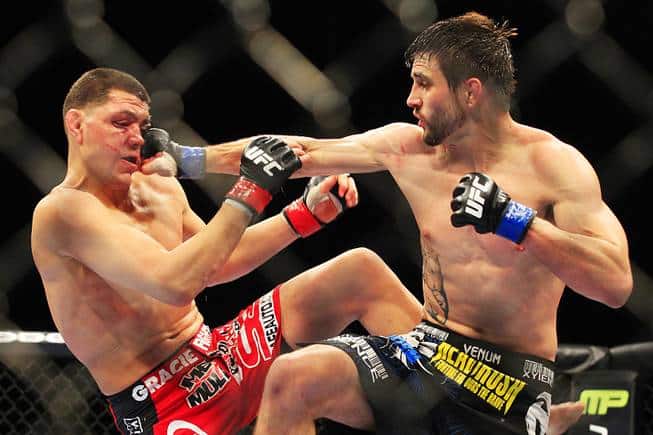 Carlos Condit lands a flush right hand to the face of Nick Diaz...