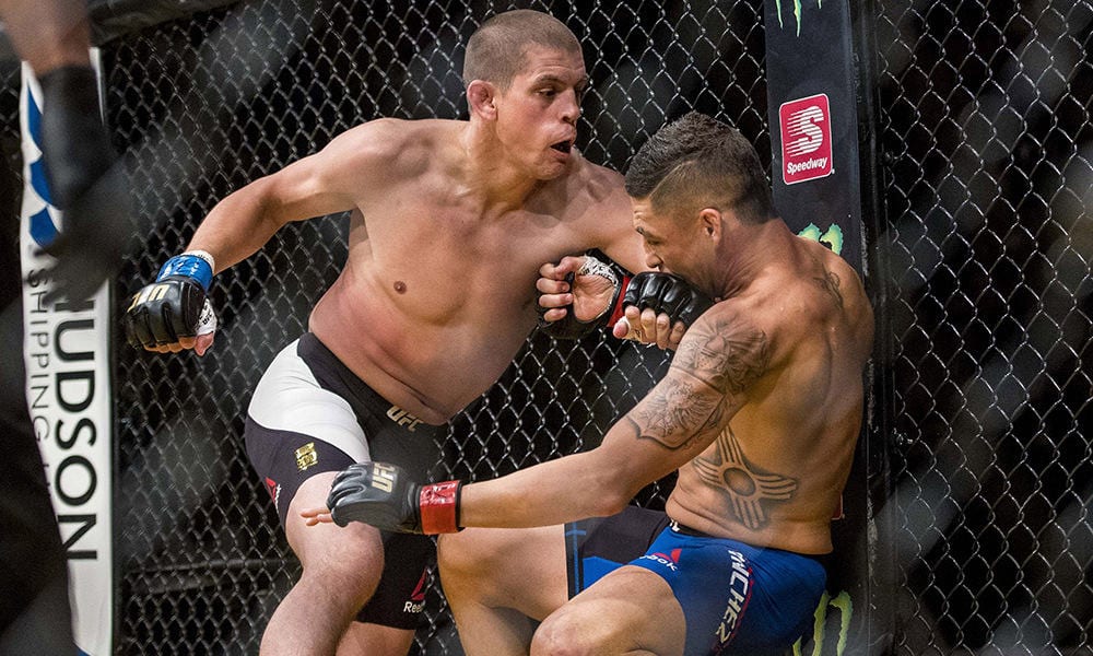 Jul 9, 2016; Las Vegas, NV, USA; Joe Lauzon (blue gloves) punches Diego Sanchez (red gloves) during UFC 200 at T-Mobile Arena. Mandatory Credit: Joshua Dahl-USA TODAY Sports