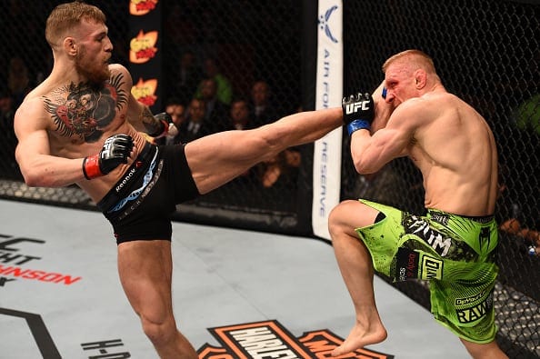BOSTON, MA - JANUARY 18:  (L-R) Conor McGregor of Ireland kicks Dennis Siver of Germany in their featherweight fight during the UFC Fight Night event at the TD Garden on January 18, 2015 in Boston, Massachusetts. (Photo by Jeff Bottari/Zuffa LLC/Zuffa LLC via Getty Images)