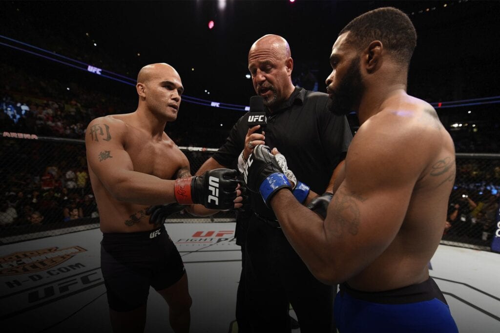 Robbie Lawler touches gloves with former teammate Tyron Woodley at UFC 201.