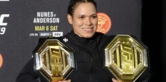 Amanda Nunes poses with her two titles after UFC 259. Photo: Drake Riggs