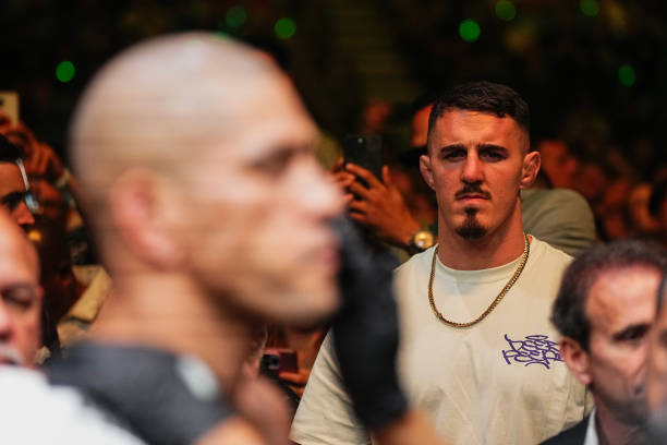 Tom Aspinall looking on as Alex Pereira takes the Octagon at UFC 300