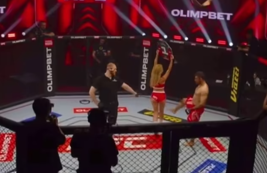 MMA fighter kicks a ring card girl