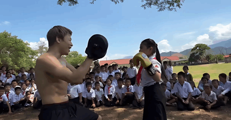 Japanese Icon Takeru Segawa Holds pads for kids in a school he helped build in Vietnam