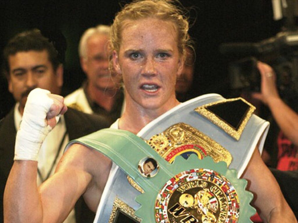 Why Did Holly Holm Sign with Jake Paul? Former UFC Champ Explains New Move 1 Holly Holm with boxing titles.