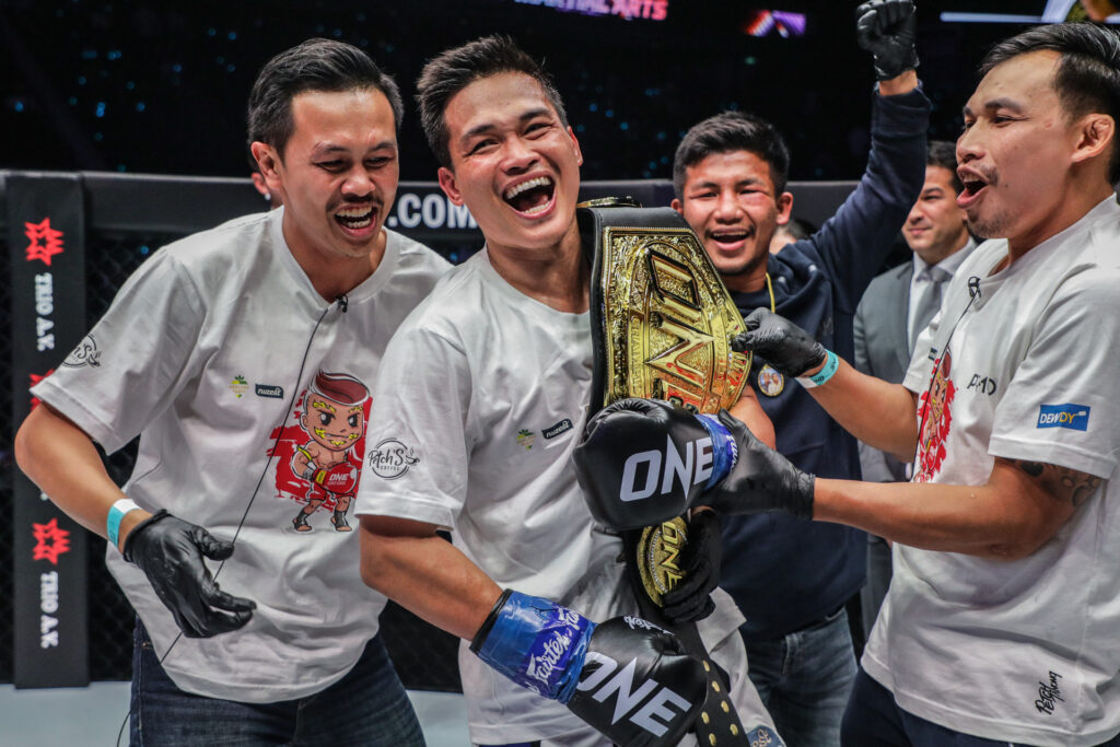 Petchanong with ONE Championship beltRodtang in background