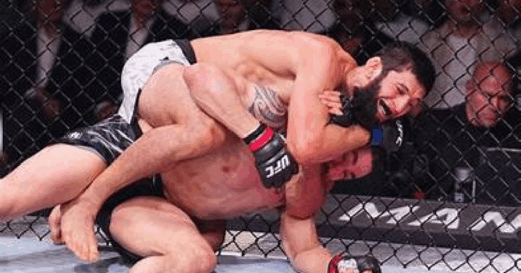 (Khamzat Chimaev securing face crank submission against Robert Whittaker)