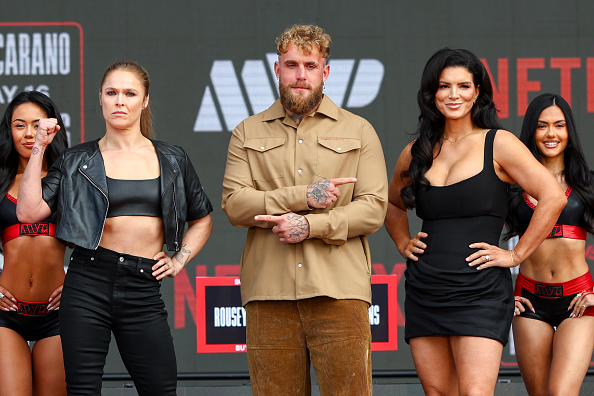 Ronda Rousey, Jake Paul, and Gina Carano pose onstage during Netflix’s Ronda Rousey x Gina Carano Los Angeles MMA Press Conference