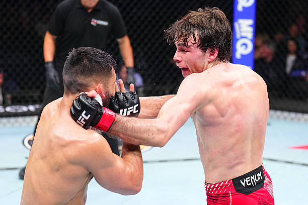 Luke Riley landing a strike during his fight against Michael Aswell Jr. at UFC London.