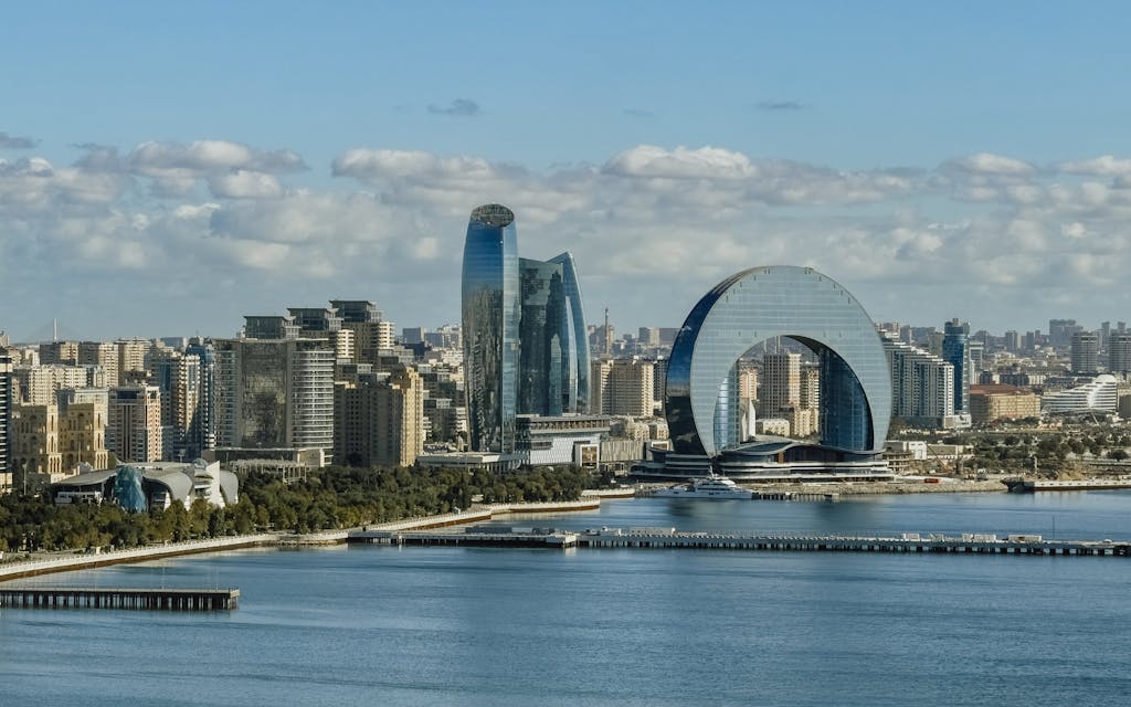Aerial view of Baku city showcasing modern architecture and Caspian Sea.