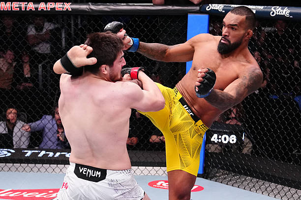 Abdul Rakhman Yakhyaev grappling with Brendson Ribeiro during their UFC Vegas 115 bout.