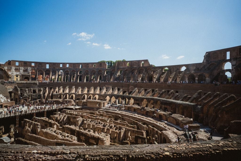 Explore the iconic Colosseum in Rome under a clear blue sky. Perfect for travel inspiration.